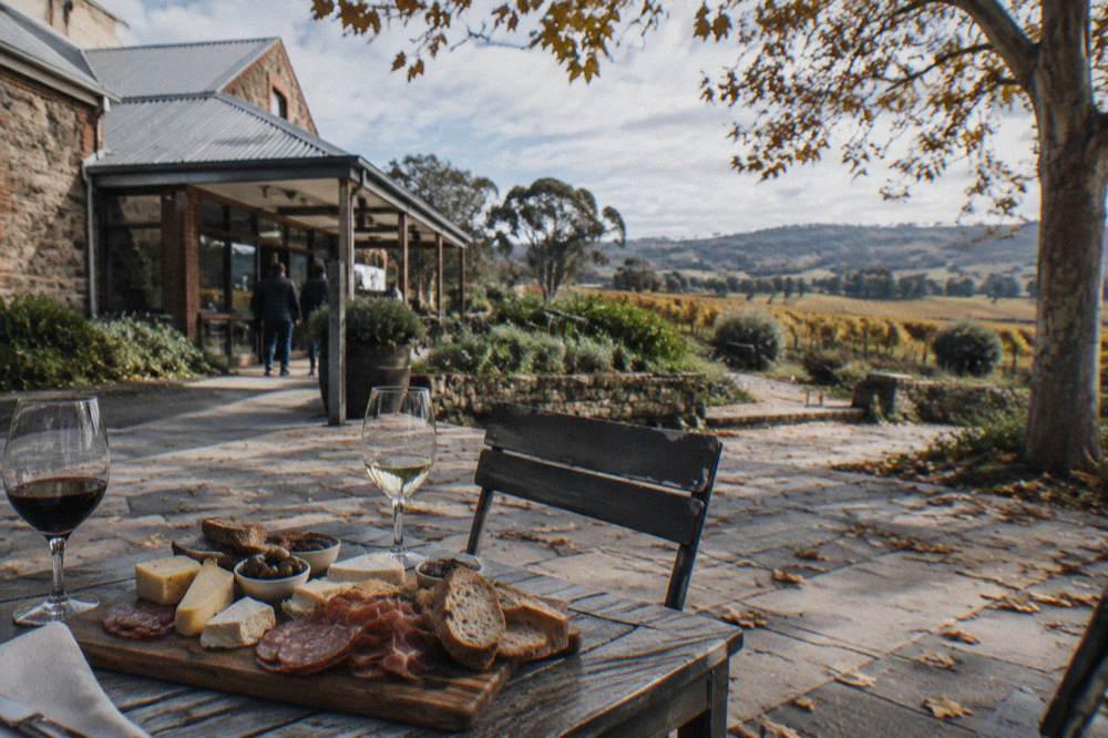 A regional platter lunch of cheese, bread and cured meats on a winery table