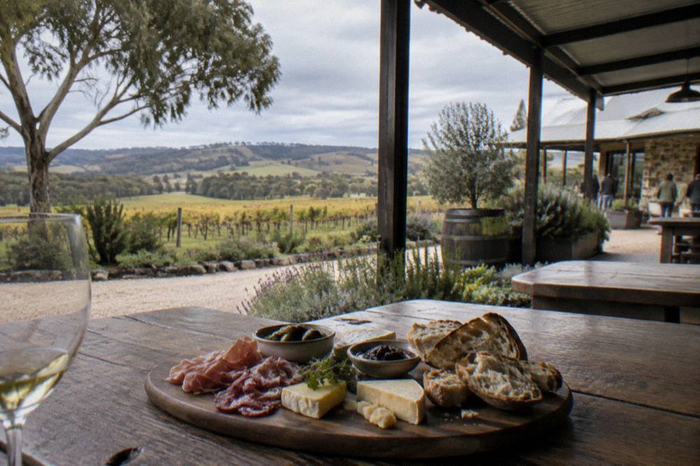 A regional platter of cheese, cured meat and bread on a winery lunch table